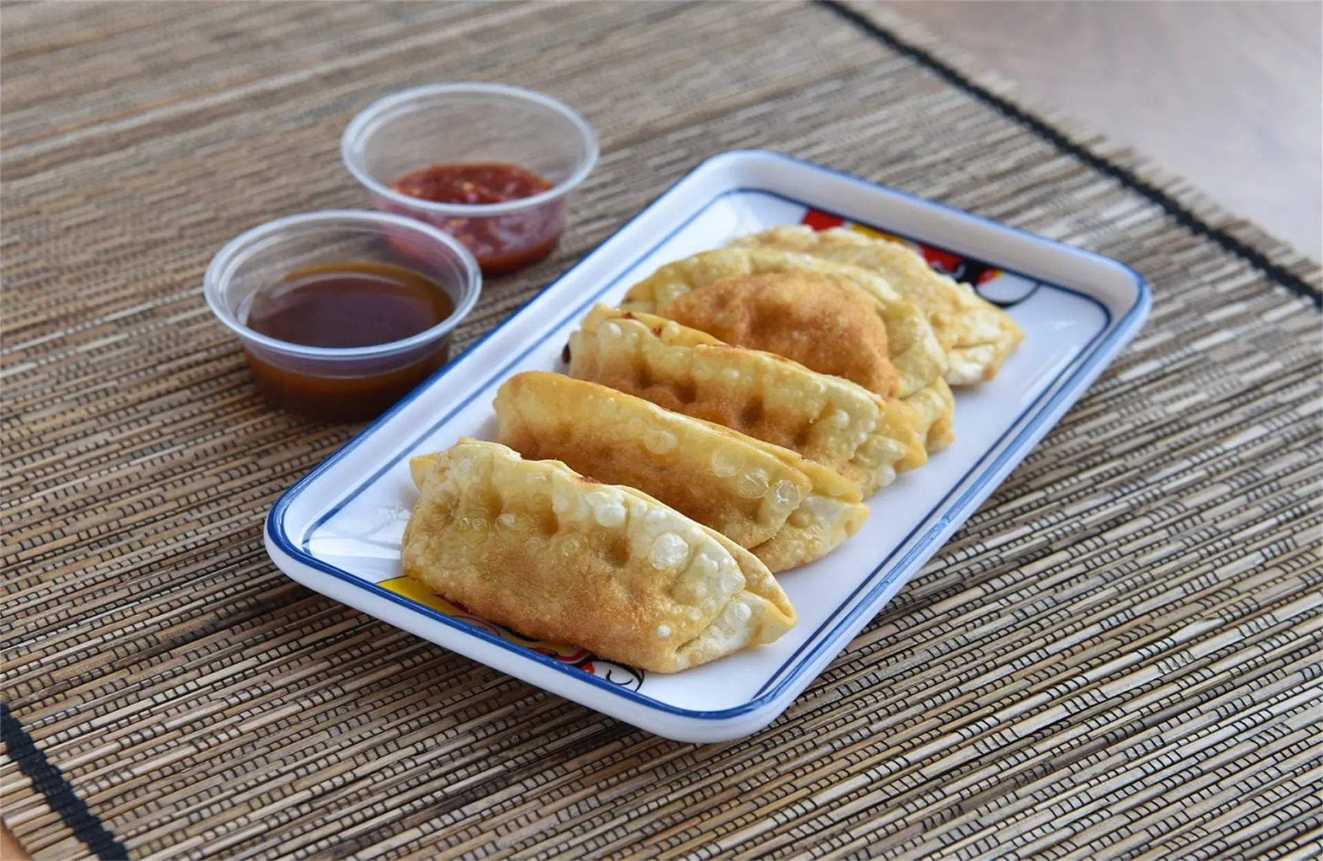 Wah-Wah-Kitchen-Inc-Chinese-Restaurant-Fried-Dumplings-With-Dipping-Sauces-Amityville Crispy fried dumplings served with two dipping sauces at Wah Wah Kitchen Inc in Amityville.